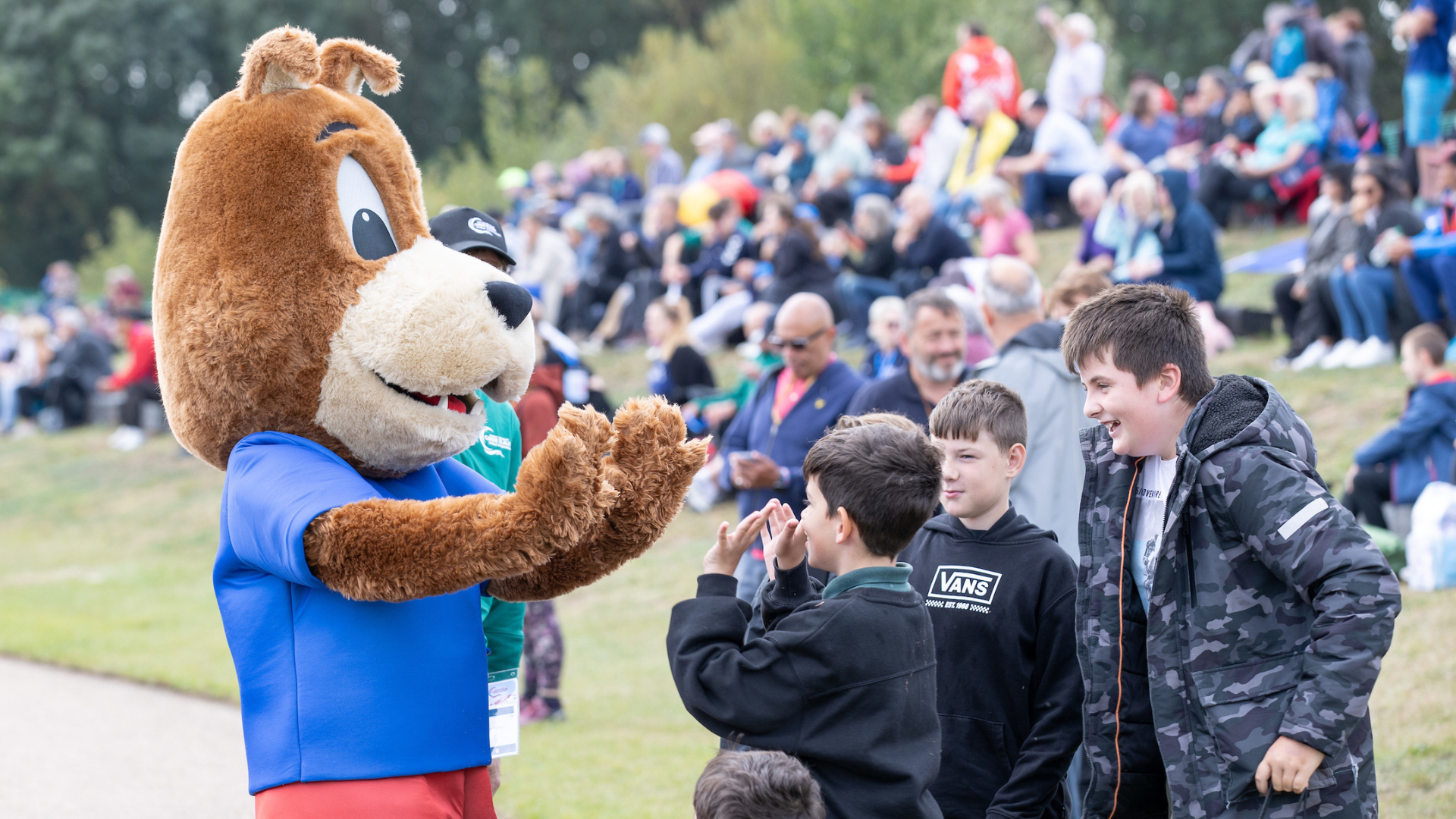 Workforce. A mascot interacting with spectators.