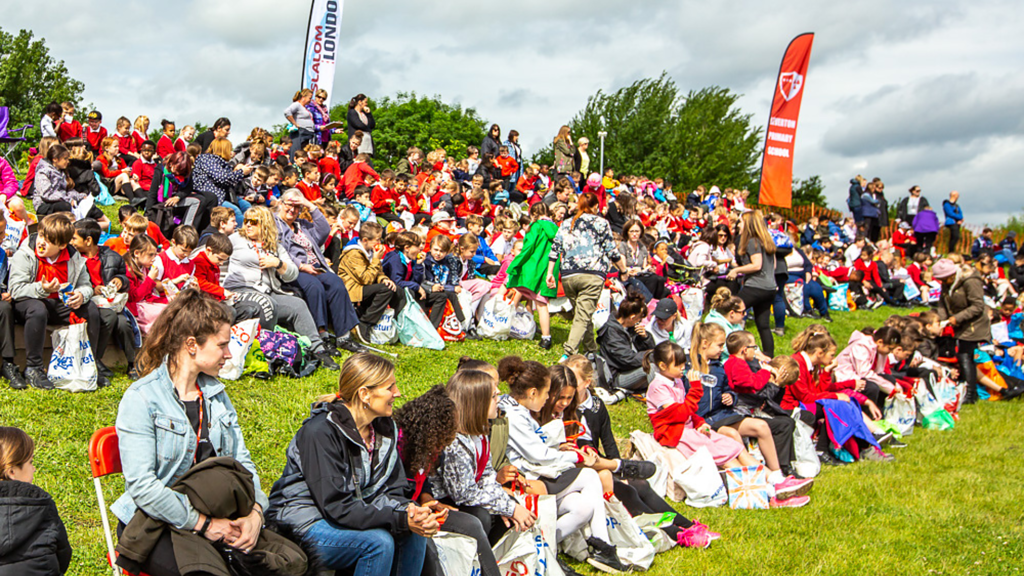 Crowd of people watching a paddling event.