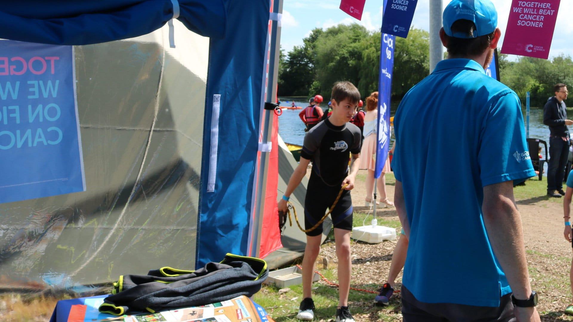 Event attendee standing in a marquee. Used on event toolkit Initial Planning page.