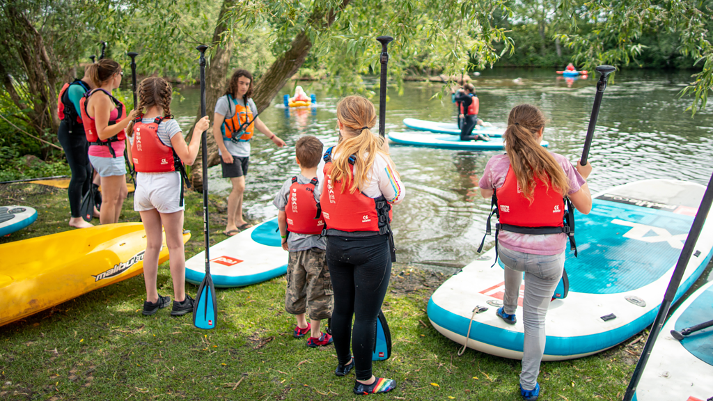 Coach with young paddlers.
