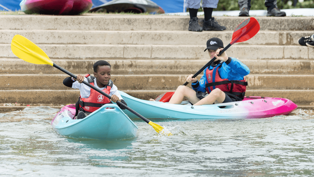 Equality, Diversity, and Inclusion. Children paddling on sit on tops.