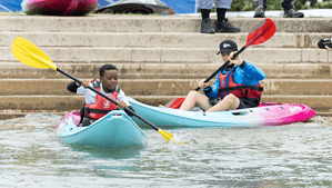 Equality, Diversity, and Inclusion. Children paddling on sit on tops.