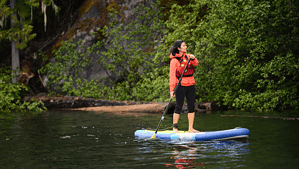 Woman on a stand up paddle board. On the Bank