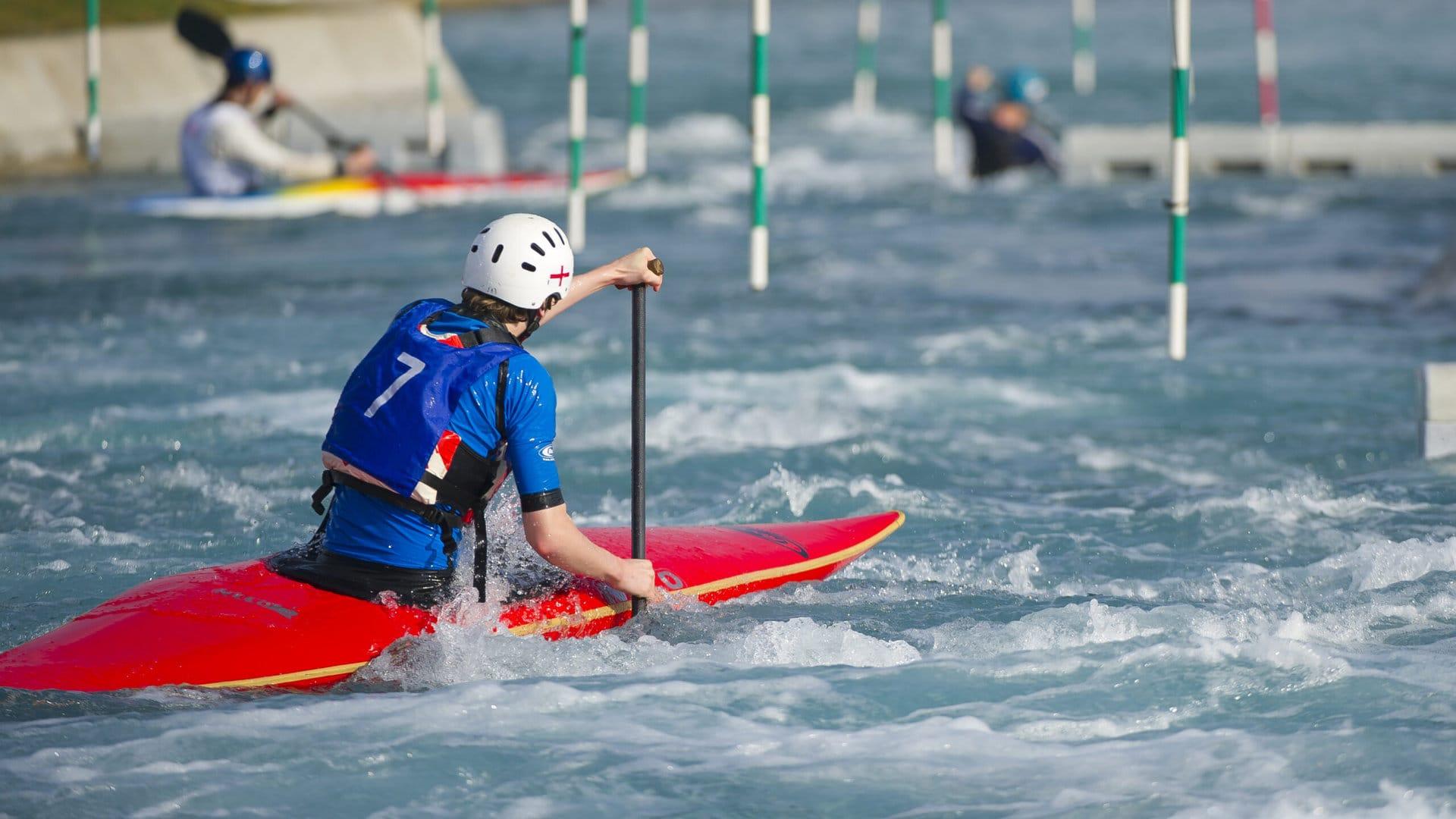 Slalom paddler in a race T Lee Valley Whitewater Centre.