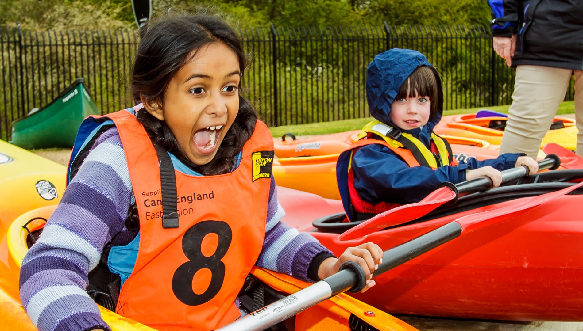 Girl in kayak screaming with joy. Used on event toolkit participant interaction page.