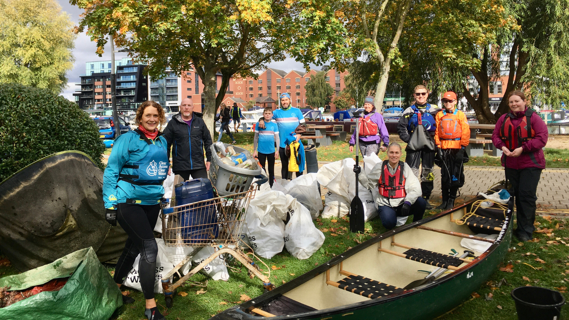 Image from the Big Paddle Clean Up with paddlers standing next to bag of collected rubbish. Used on event toolkit Environment page.