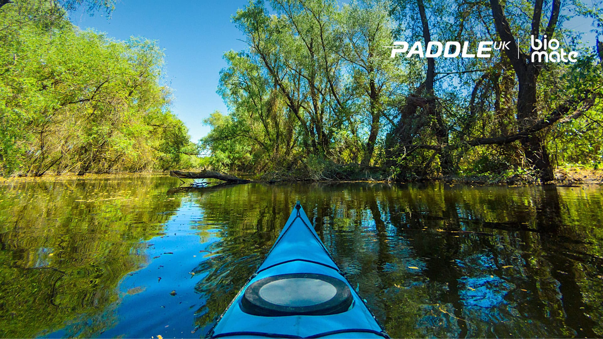 Kayak on water with Paddle UK and bio mate logos