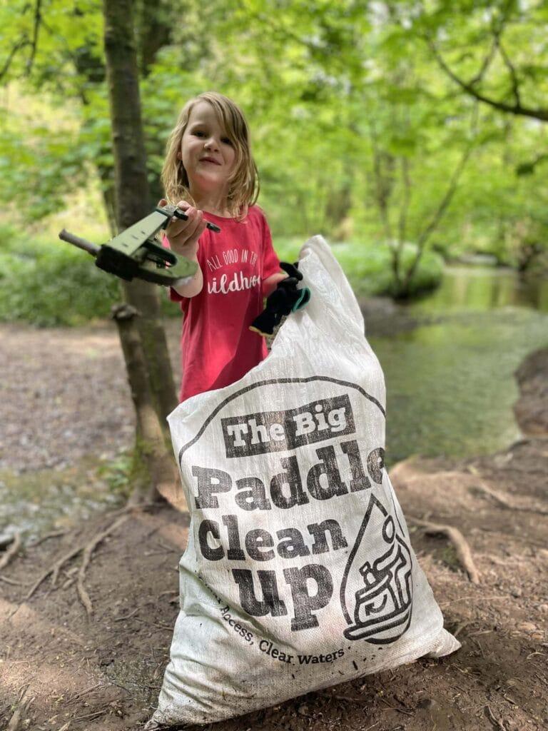 Girl collecting rubbish for the Big Paddle Clean-up 