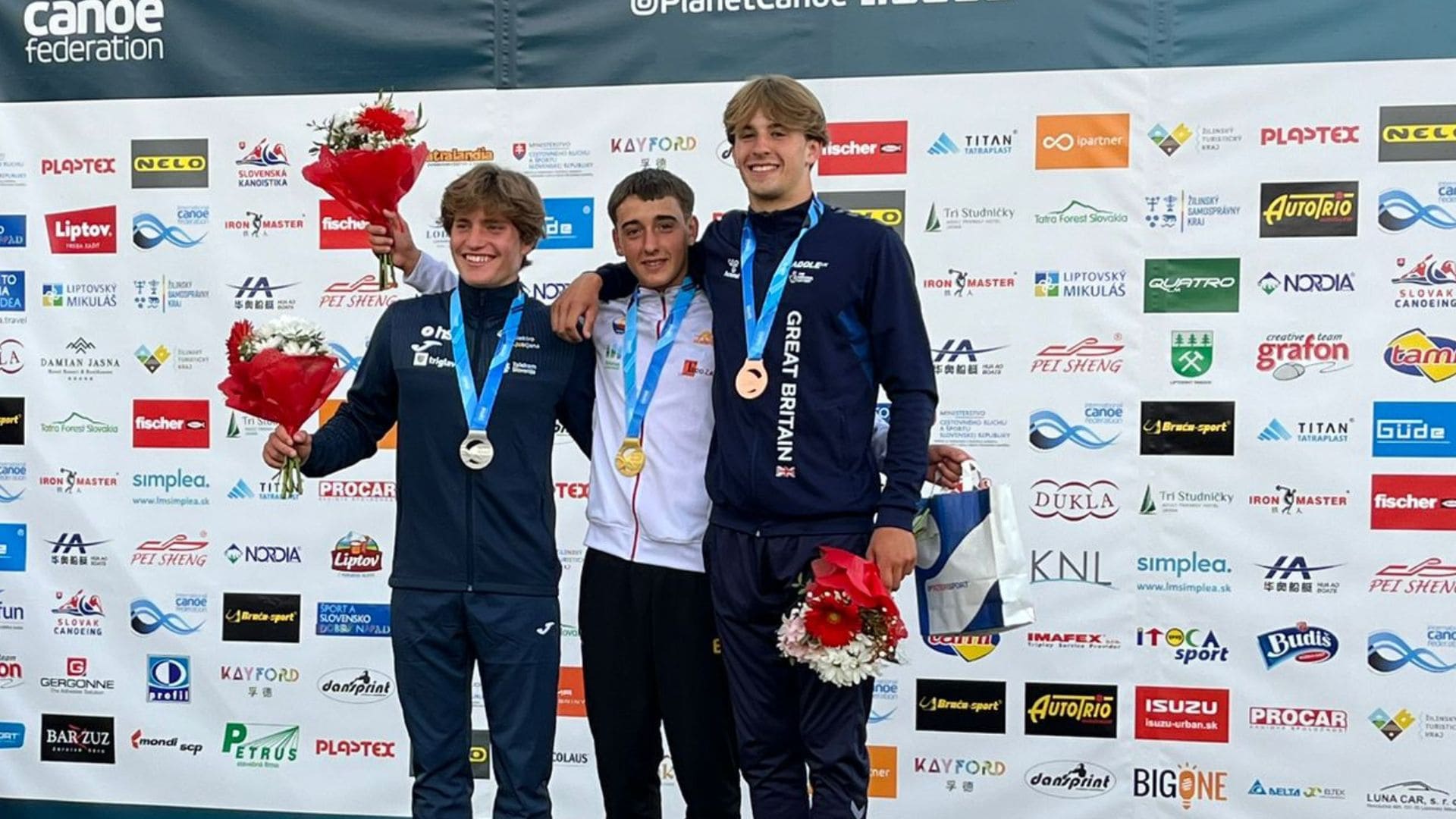 Jonah Hanrahan on the podium for winning the bronze medal in kayak cross at the Junior World Championships in 2024.