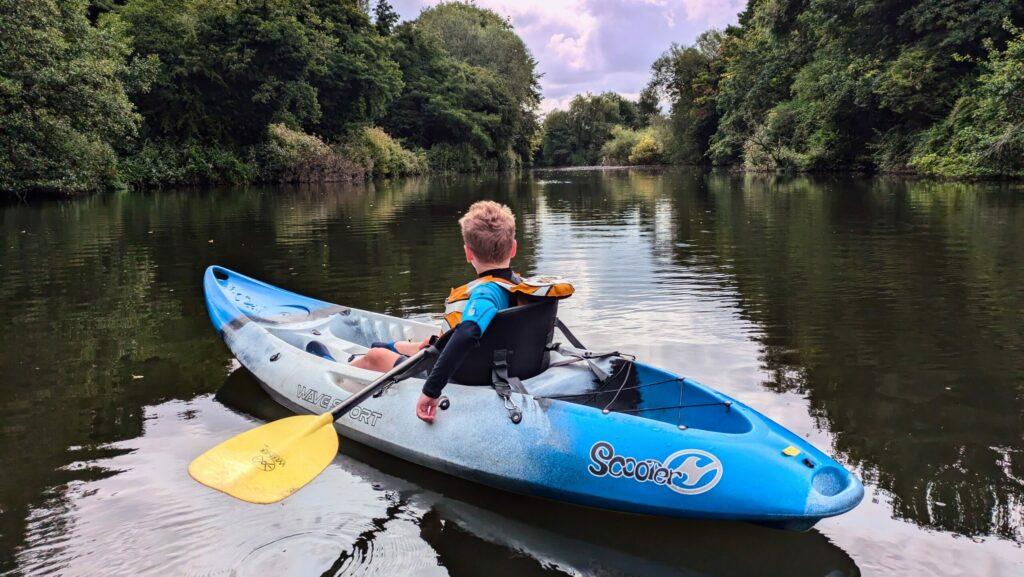 Child paddling on a river