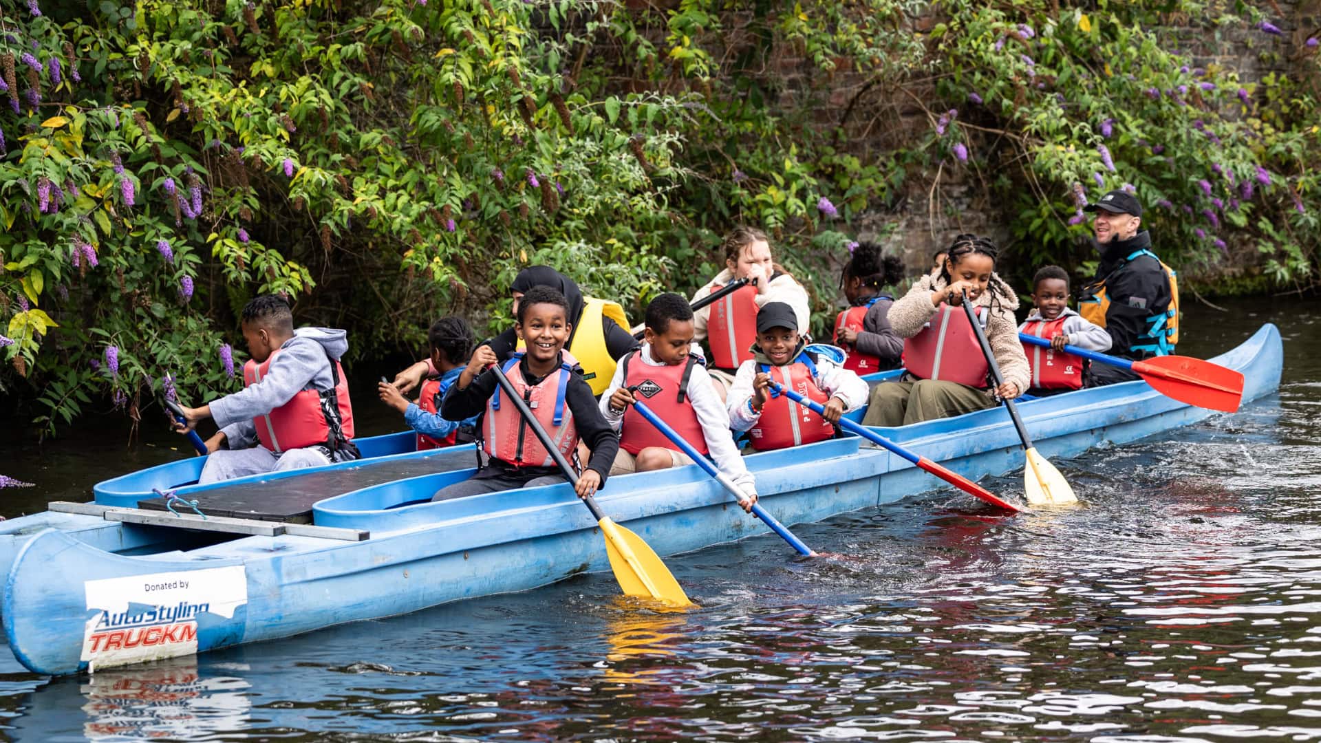 Birmingham Community Paddlesports. Group of participants bellboating on the Birmingham Canal.