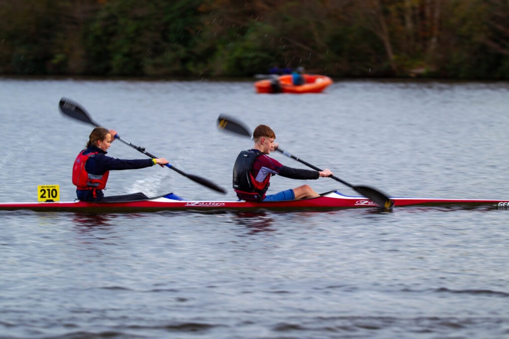 Image of a K2 crew boats competing in a kayaking race at the National School Canoe Championships