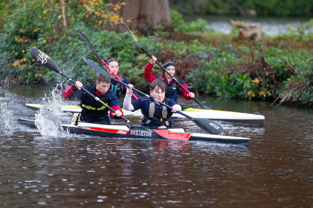 Image of two K2 crew boats competing in a kayaking race at the National School Canoe Championships