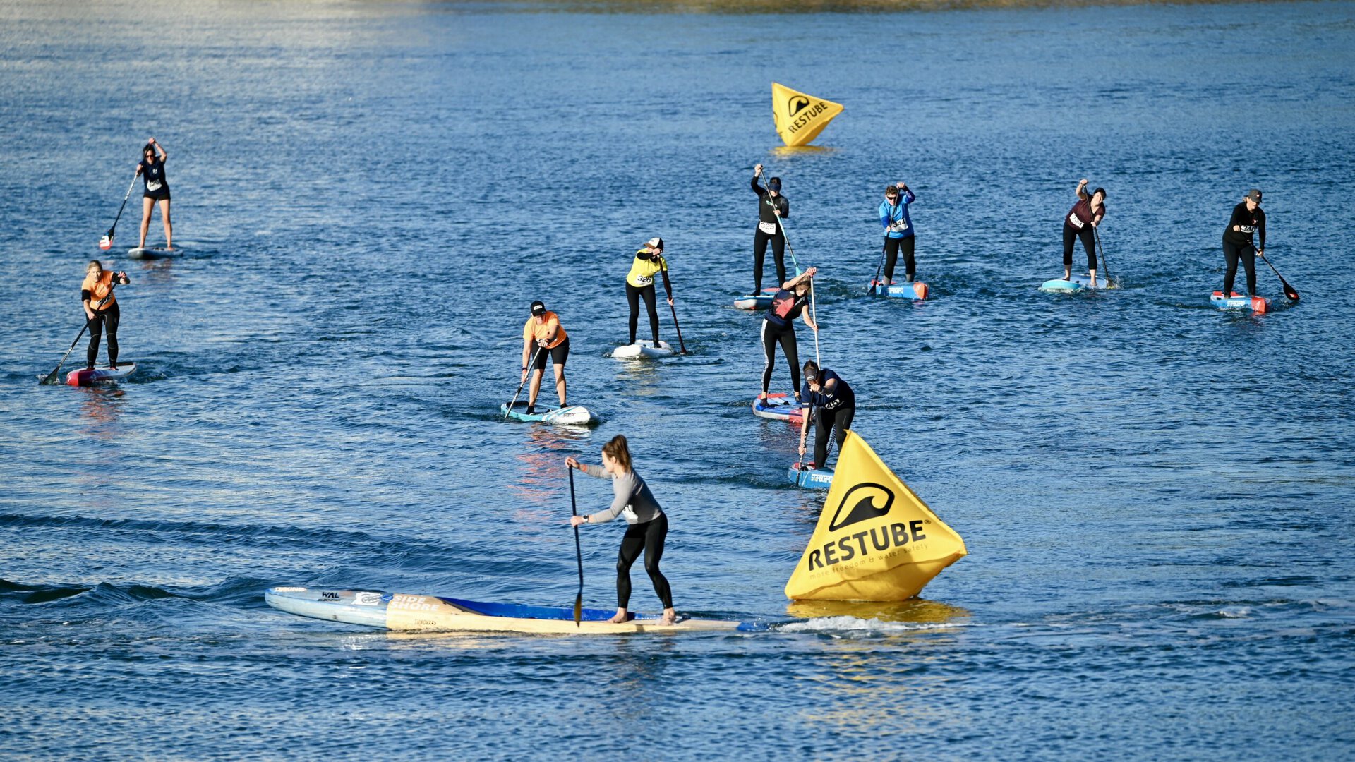 A group of people on surfboards in the water.