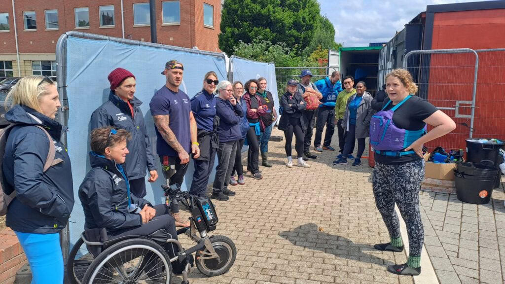 Chantelle Grundy, Access and Environment lead at Paddle UK, gives a Big Paddle Cleanup briefing to staff and athletes