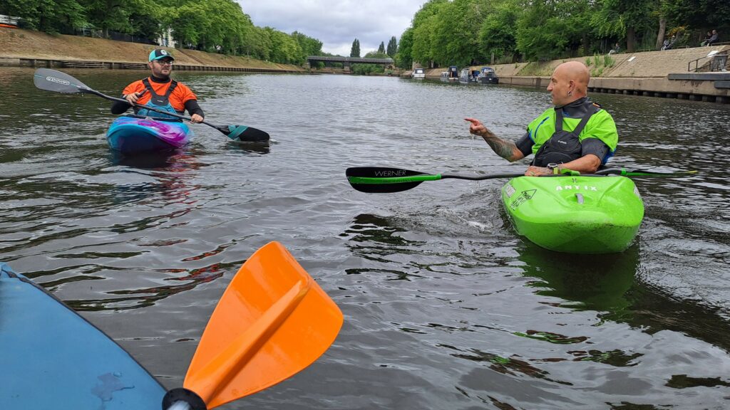 Two paddlers have a chat on the River Ouse