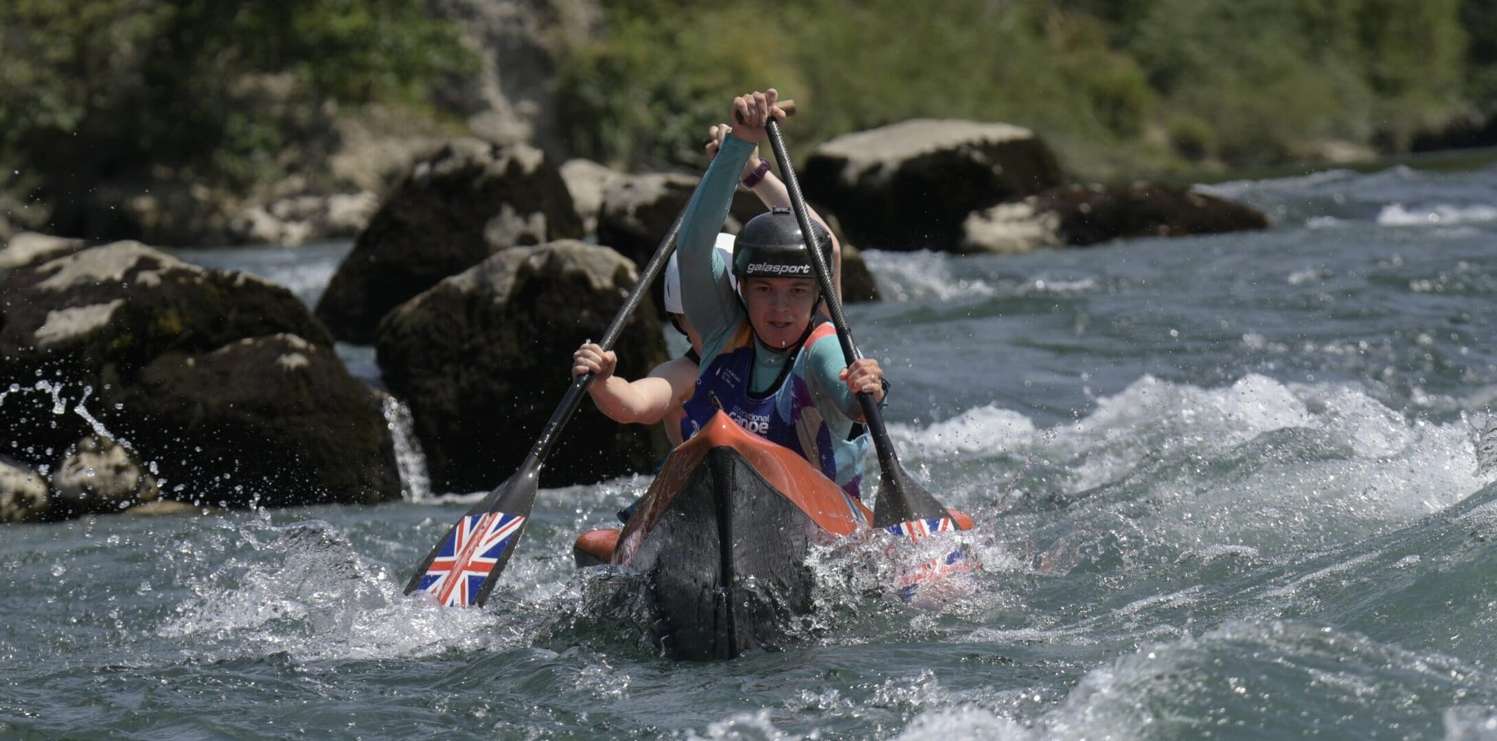 Two GB athletes canoeing down a wildwater course.
