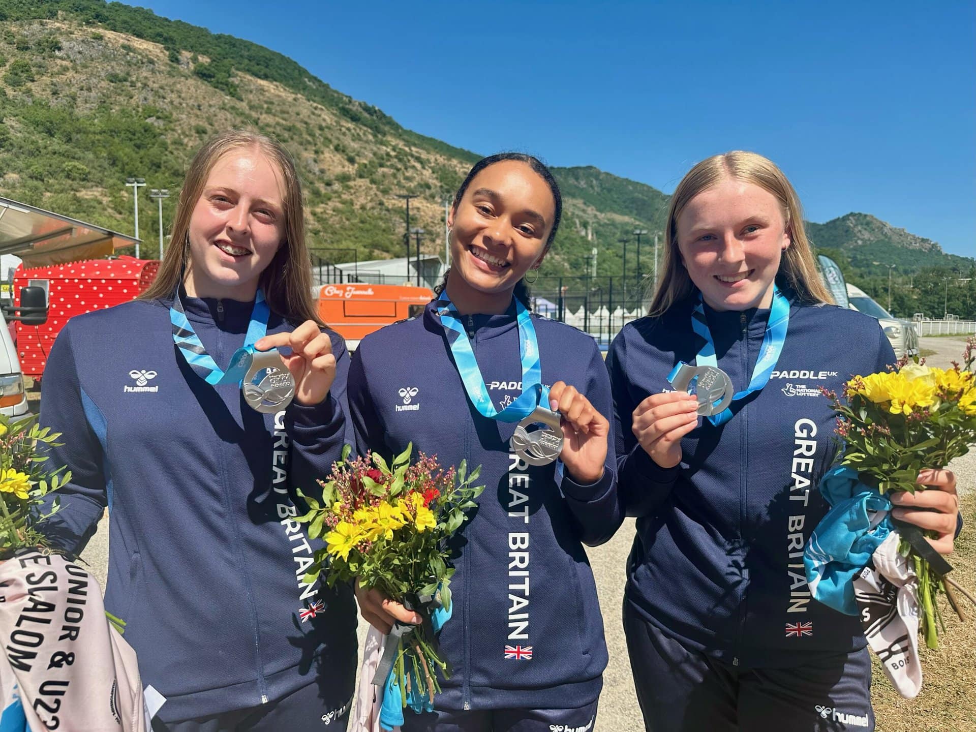 GB canoeists Blythe-Shields, Wilde, and McMullins pose with their silver medals.