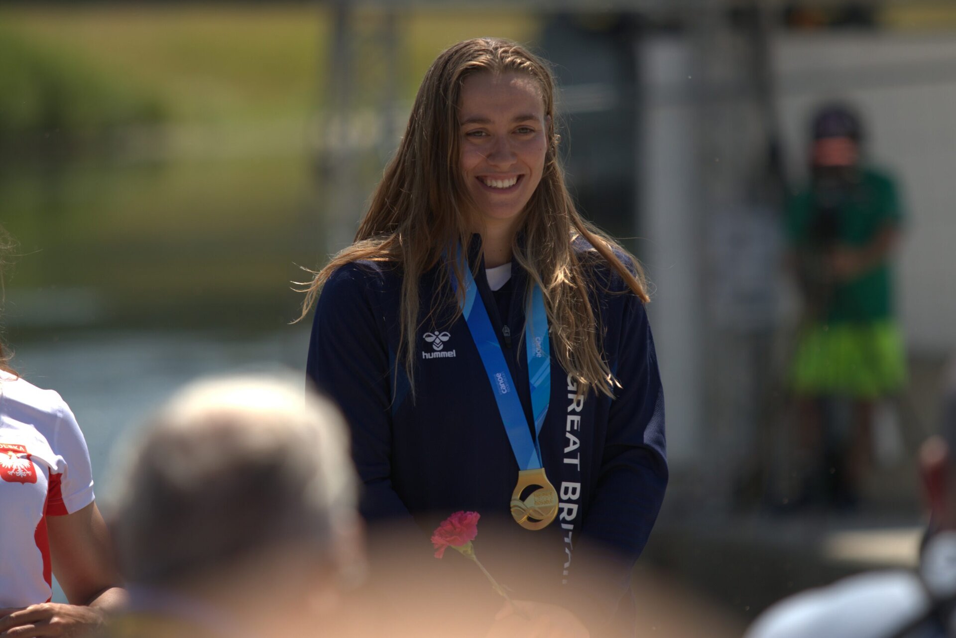 A British freestyle canoer receiving a gold medal