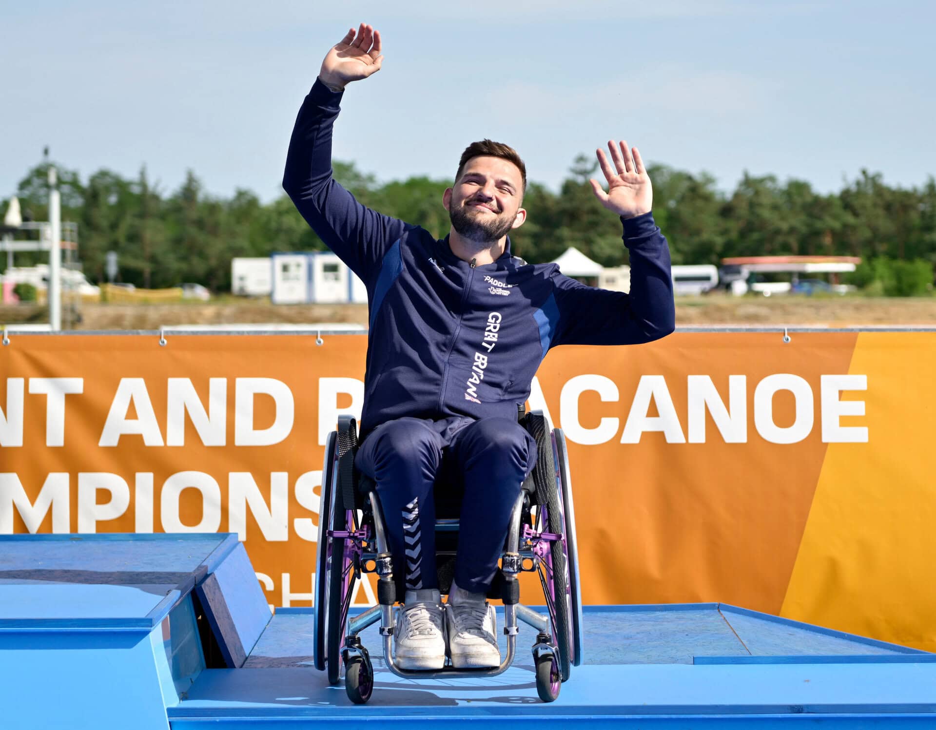 Taylor Gough (GBR) gets onto the podium during the ECA Canoe sprint and Paracanoe European Championships in Recice, Czechia.