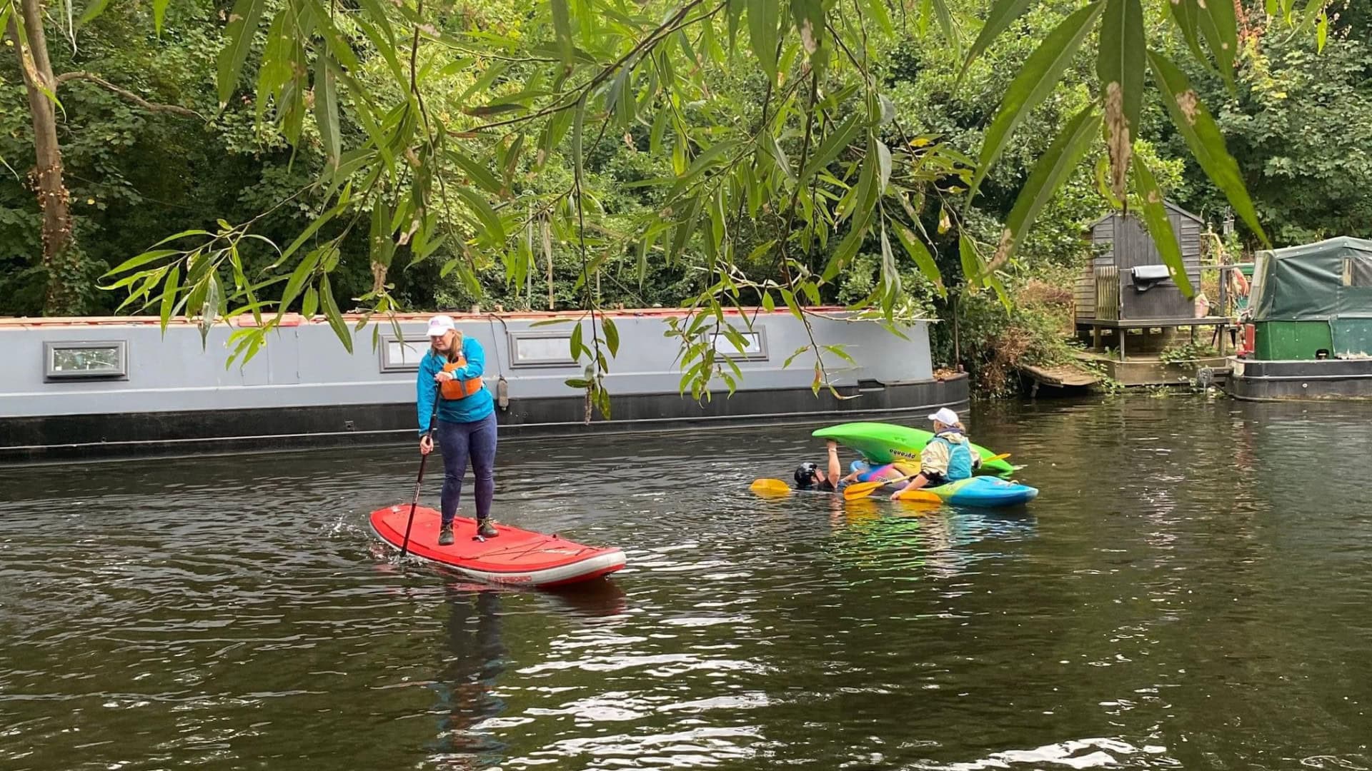 #ShePaddles East Midlands 2024 event. Women coaching on the water and practing rescues in kayaks.