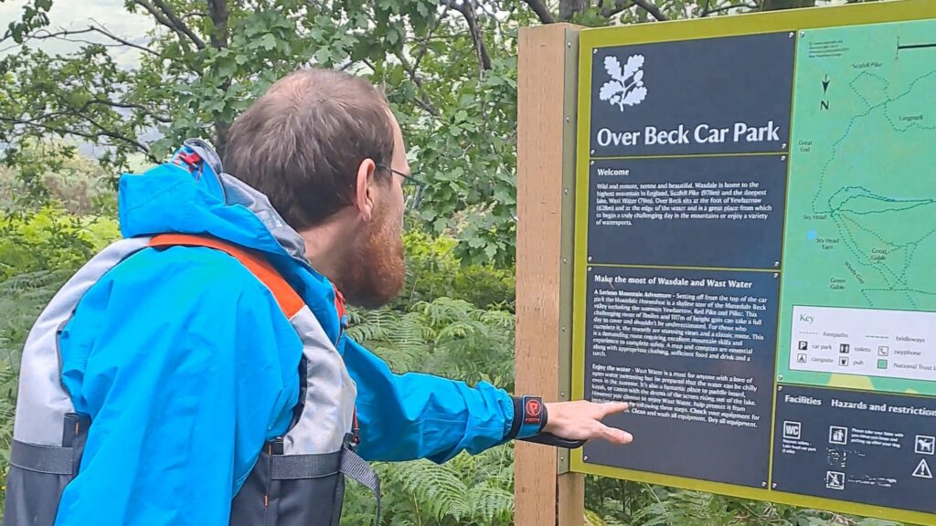 Checking the information at Over Beck car park
