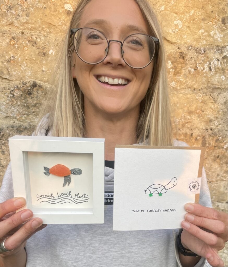 Flora with the art and cards she's made from plastic