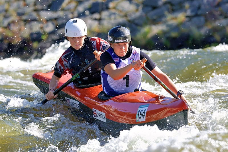 Kerry and Emma Chrsitie canoeing through whitewater