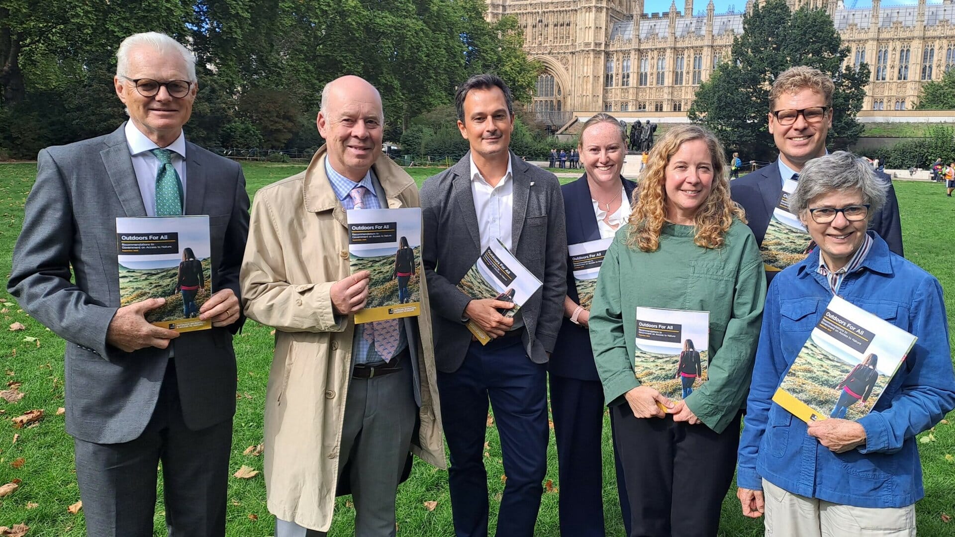 Group of people show the APPG report at Parliament
