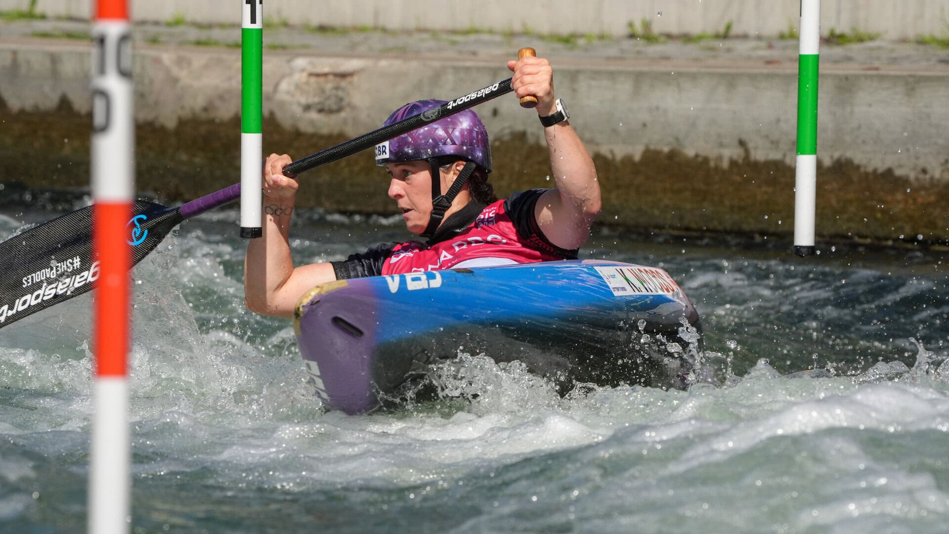Kimberley Woods paddling hard in her canoe through the slalom course in Augsburg, Germany.