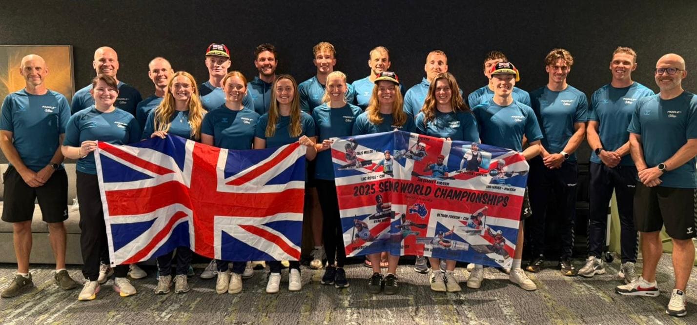 The British slalom team - athletes and staff holding up two Union Jack flags
