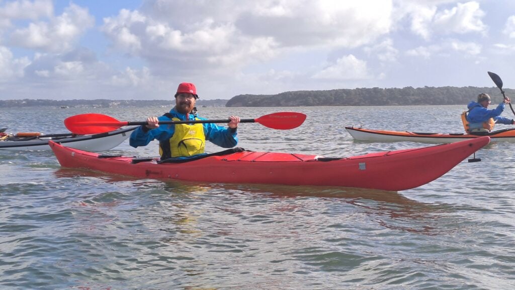 Man in sea kayak poses for the camera