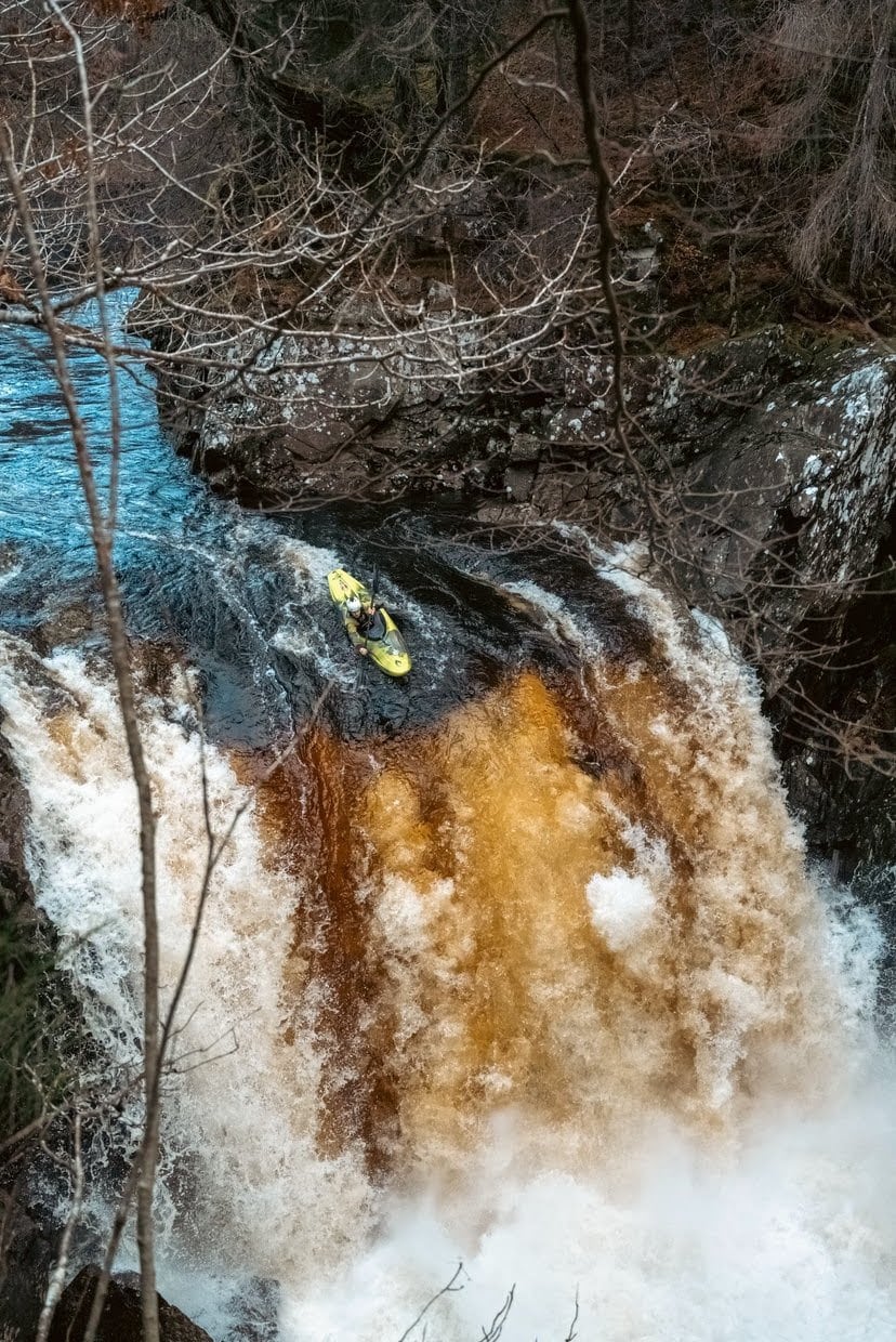 White water kayaker Alex Littlechild paddling down the Guardian Angel waterfall on the River Spean in Scotland.