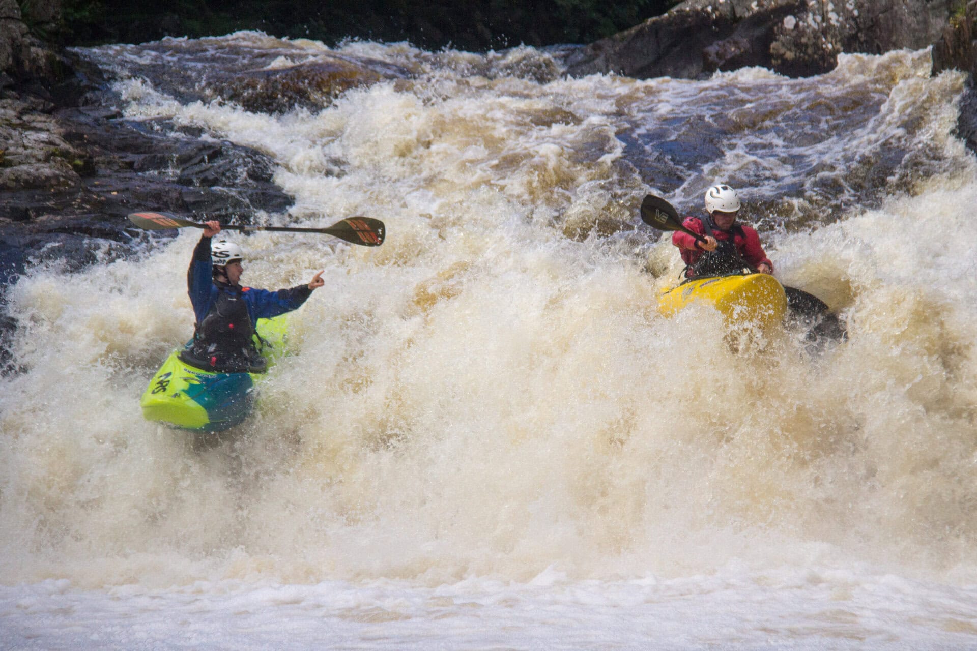 Alex Littlechild coaching another kayaker on whtie water