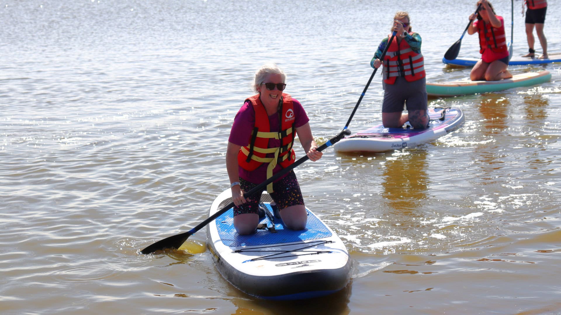 Female on stand up paddleboard at Mersea Water Park on the #ShePaddles Weeeknder