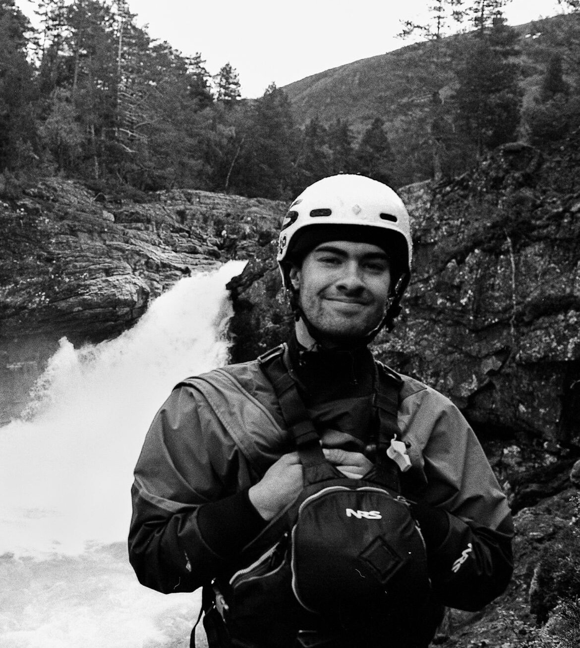 Alex Littlechild stood in front of a waterfall