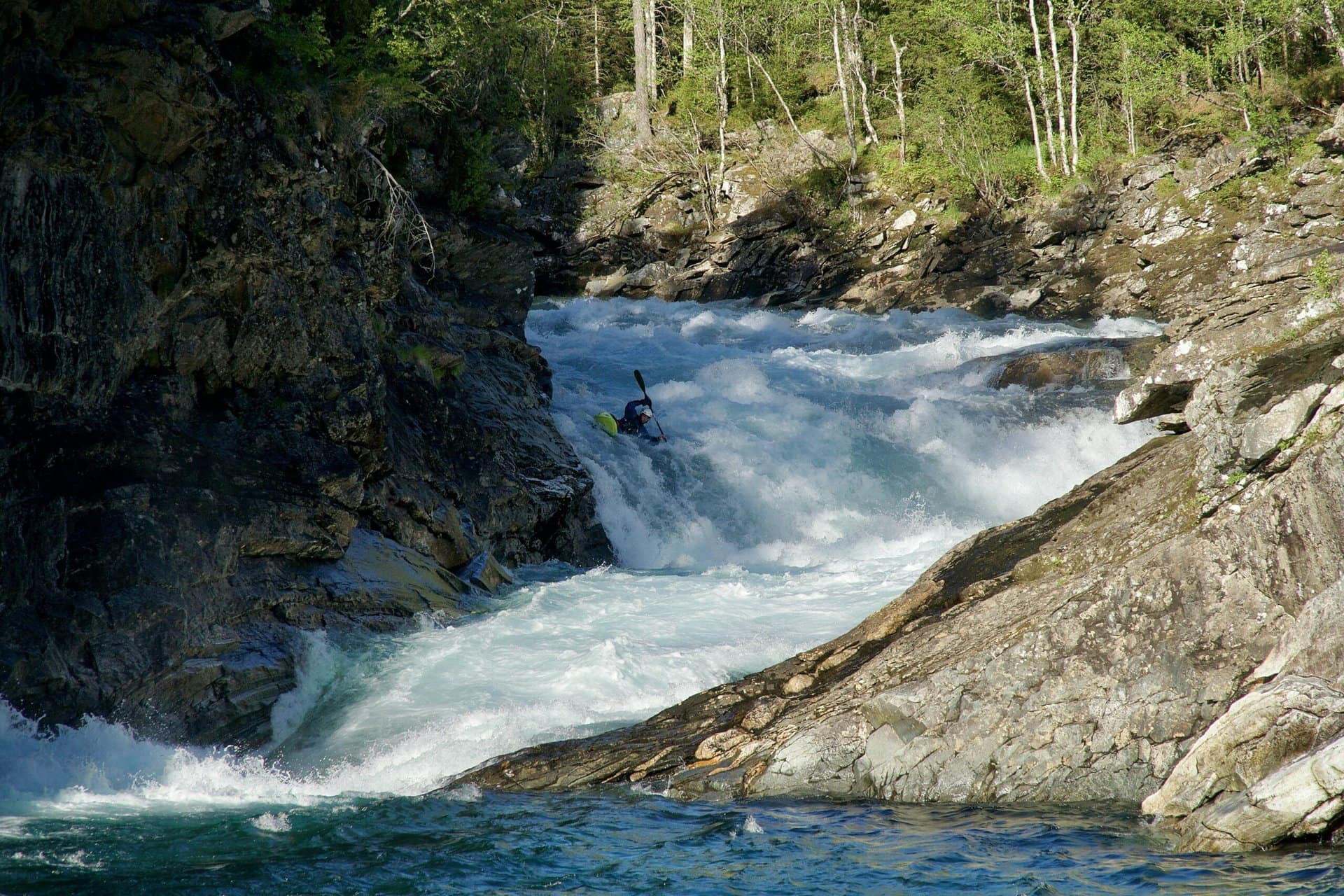 Alex Littlechild paddling on white water at Timber hole in Raundalselvi in Norway