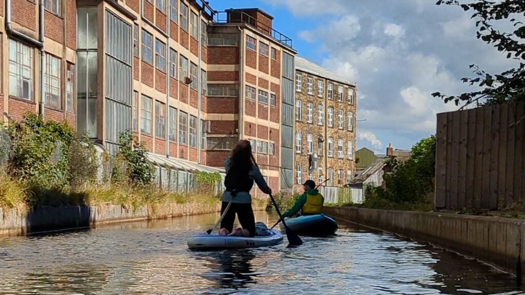 Paddling the Peak Forest Canal near buildings